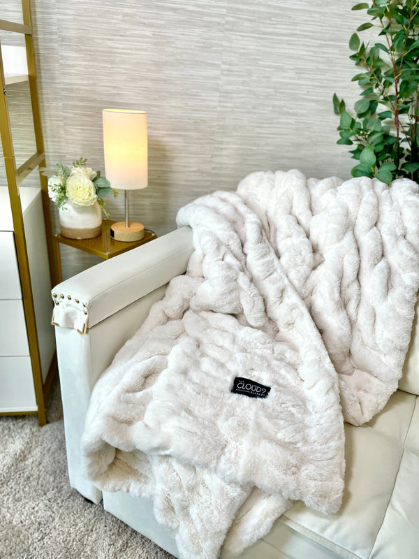 Ribbed Faux Fur Ivory Blanket — Channel-quilted faux fur throw in a warm ivory, weighted for daily use