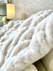 Ribbed Faux Fur Ivory Blanket draped over a linen sofa arm