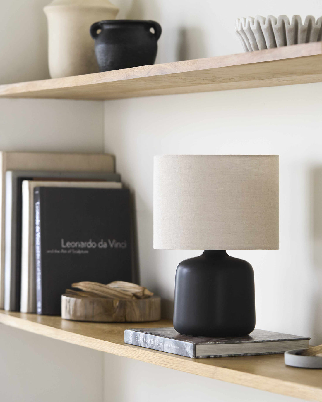 Matte Ceramic Drum Shade Table Lamp — Matte black ceramic base with a natural linen drum shade for ambient light