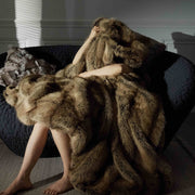 Long-Pile Faux Fur Throw Blanket draped over a linen sofa arm