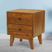 Two-Drawer Solid Wood Nightstand styled beside a bed with a lamp and book
