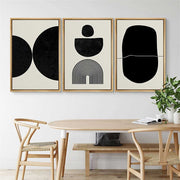 Abstract Geometric Canvas Triptych hung on a warm neutral wall above a sofa