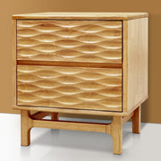 Relief-Carved Rubber Wood Nightstand styled beside a bed with a lamp and book