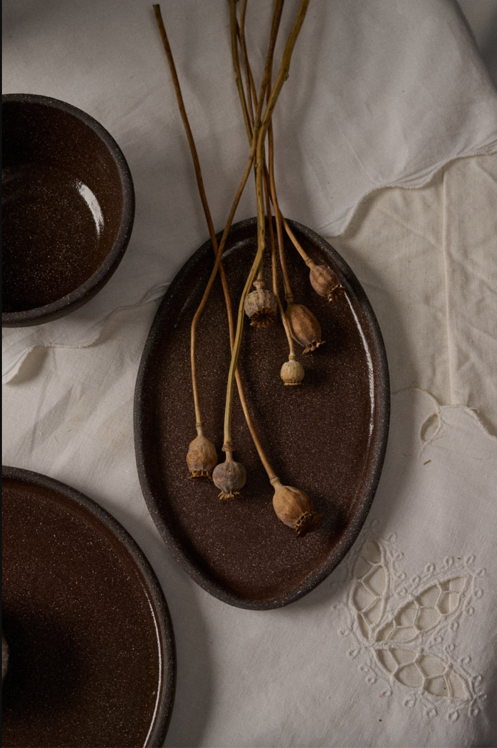 Oval Stoneware Serving Platter — Dark grit-flecked stoneware platter, handformed in two sizes for everyday serving