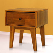 Mid-Century Wood Nightstand styled beside a bed with a lamp and book