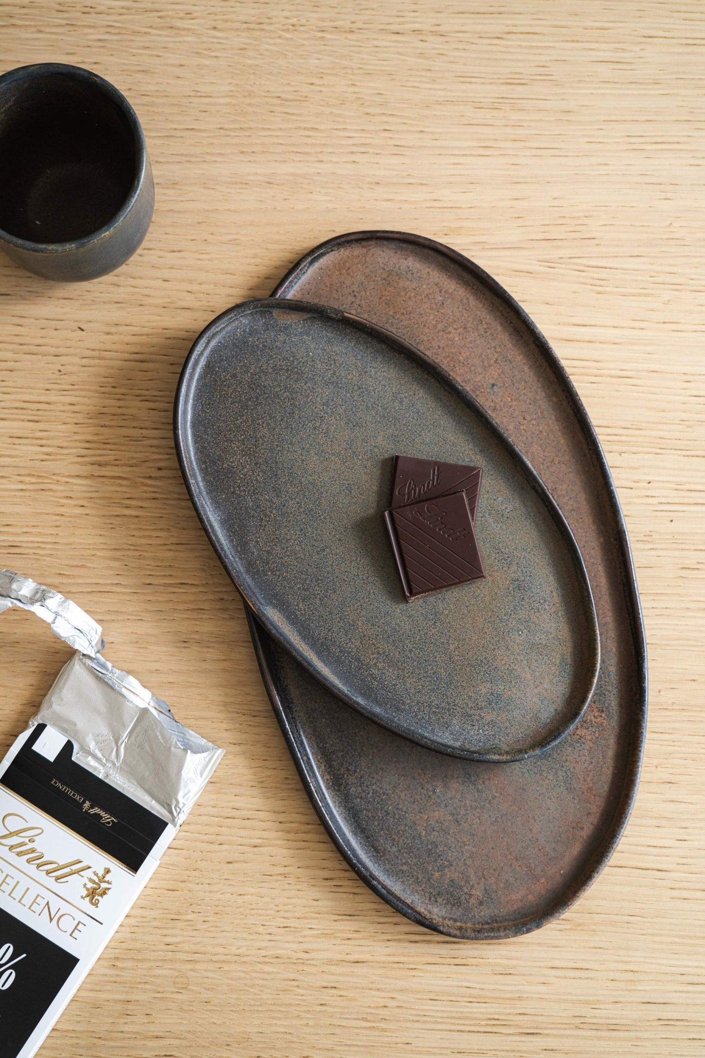 Reactive Glaze Oval Stoneware Platter — Hand-dipped reactive glaze stoneware platter in rust and iron tones