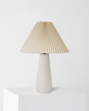 Pleated Shade Ceramic Table Lamp — Tapered ceramic base with a wide pleated shade for warm, diffused light