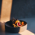 Micro Terrazzo Concrete Round Platter — Thick-walled concrete platter in five micro terrazzo finishes, for table or counter