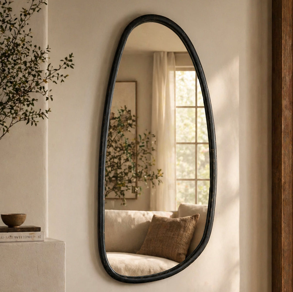 A mirror that holds the room as much as it reflects it