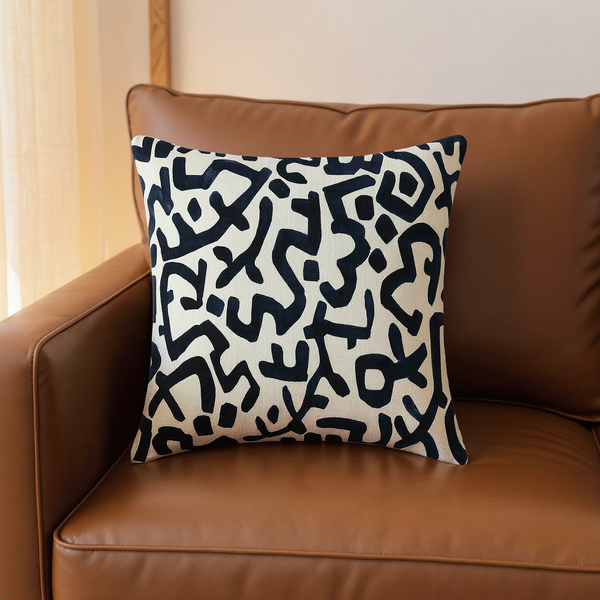 Abstract Print Cotton Slub Pillow in a close view on coordinated upholstered seating