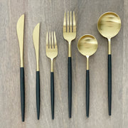 Matte Black and Gold Flatware Set — Six-piece flatware set with matte-black handles and brushed gold-tone heads