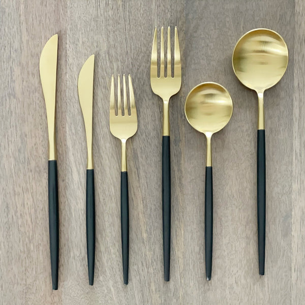 Matte Black and Gold Flatware Set — Six-piece flatware set with matte-black handles and brushed gold-tone heads