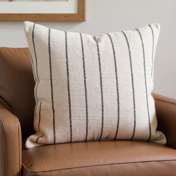 Backstrap-Woven Striped Cotton Pillow in a close view on coordinated upholstered seating