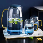 Ombre Glass Pitcher and Cup Set — Gradient tinted glass pitcher and two handled cups with gold-tone accents