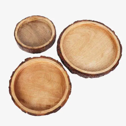 Live-Edge Mango Wood Bark Bowl Set styled on a kitchen counter with produce