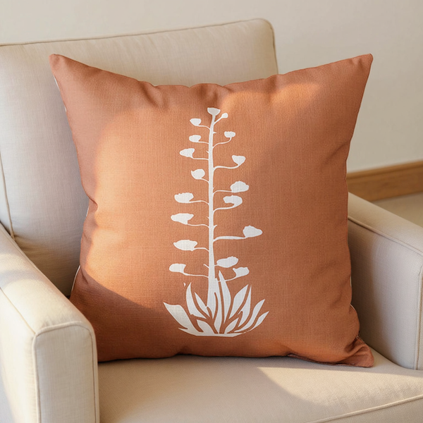 Terracotta Botanical Print Linen-Blend Throw Pillow with white agave design on an ivory linen lounge chair