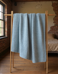 Boucle-Texture Oversized Throw Blanket in pale blue, styled in a warm editorial loft