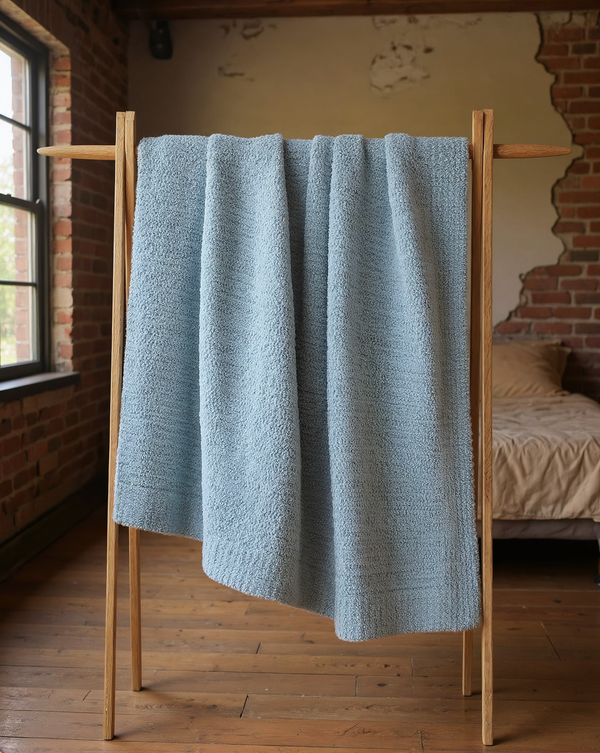 Boucle-Texture Oversized Throw Blanket in pale blue, styled in a warm editorial loft