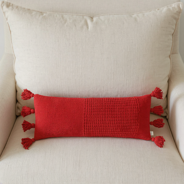 Braided Pom Pom Lumbar Pillow styled on coordinated seating