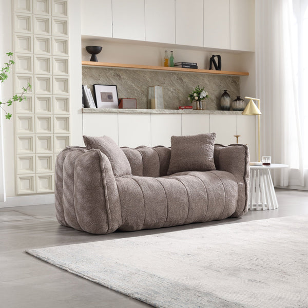 Boucle Channel-Tufted Loveseat Sofa styled with cushions on a terrace setting