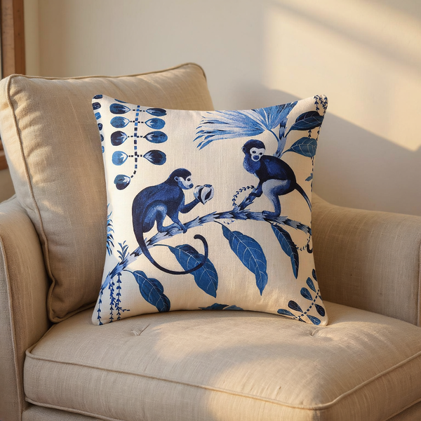Cobalt Botanical Monkey Cotton Pillow in a close view on coordinated upholstered seating