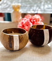 Hand-Poured Coconut Shell Candle styled on a table with linen and ceramics