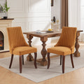 Channel-Tufted Ochre Upholstered Dining Chairs — Ochre woven dining chairs with channel-tufted backs and curved wood-tone