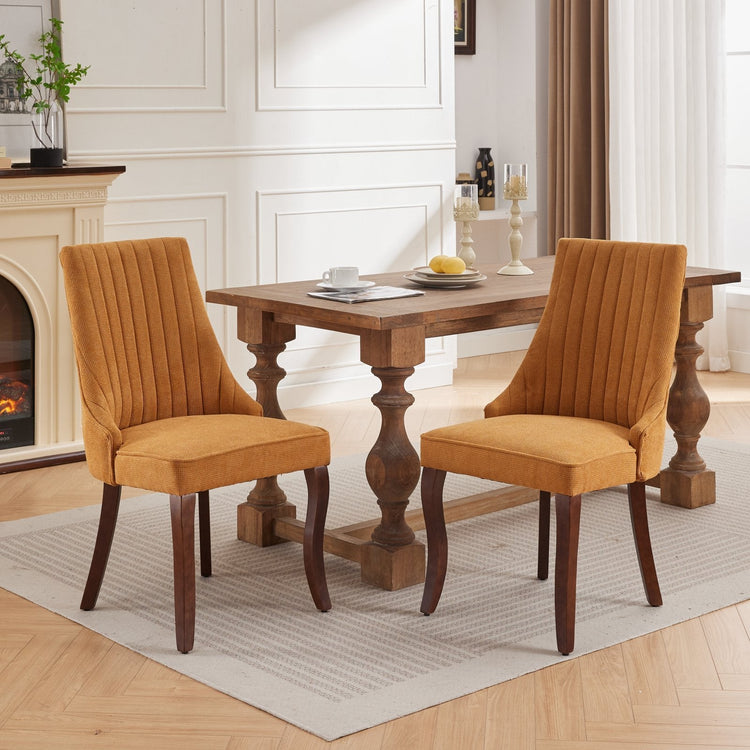 Channel-Tufted Ochre Upholstered Dining Chairs — Ochre woven dining chairs with channel-tufted backs and curved wood-tone