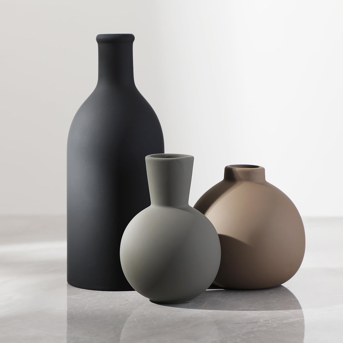 Matte Ceramic Vase Set — Three matte ceramic forms in tonal neutrals, shaped for shelves and sideboards
