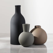 Matte Ceramic Vase Set — Three matte ceramic forms in tonal neutrals, shaped for shelves and sideboards