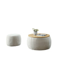 Upholstered Round Storage Ottoman Table styled with ceramics and a linen runner
