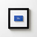 Wood-Frame Script Art Print — Cobalt script print in a wood-grain frame, available in three finishes