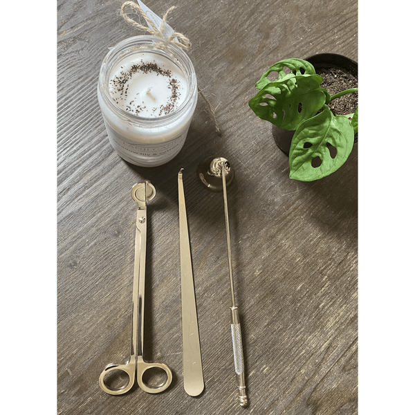 Brass-Finish Candle Care Tool Set styled on a table with linen and ceramics