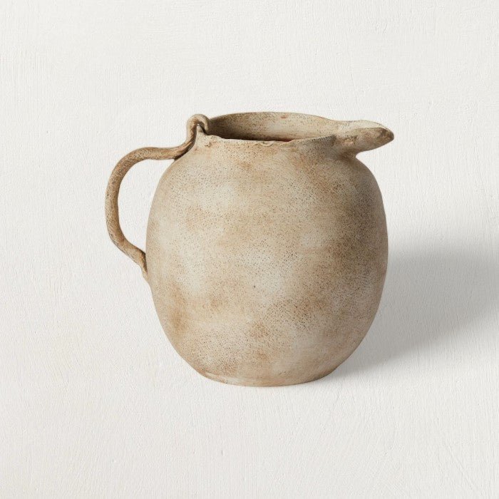 Speckled Matte Ceramic Pitcher — Hand-formed ceramic pitcher in matte off-white with warm earth-tone speckle