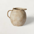 Speckled Matte Ceramic Pitcher — Hand-formed ceramic pitcher in matte off-white with warm earth-tone speckle