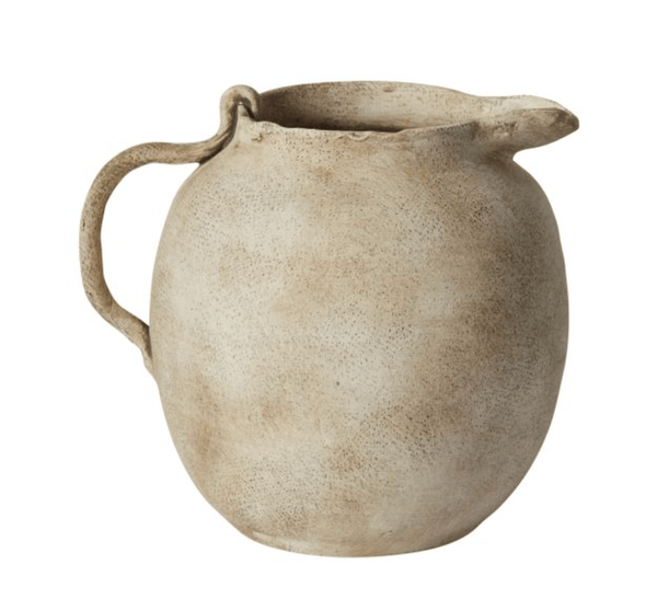 Speckled Matte Ceramic Pitcher styled on a countertop with fresh botanicals