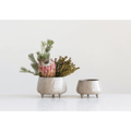 Stoneware Footed Planter with Glazed Finish holding a trailing plant on a patio