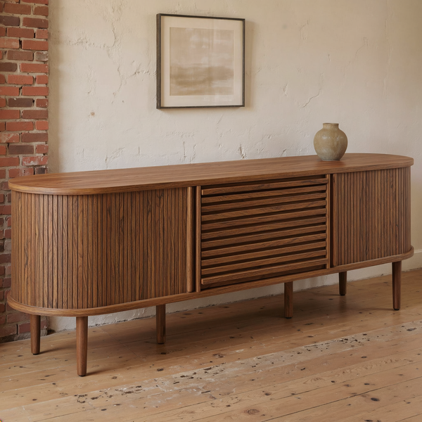 Fluted Oval Walnut Sideboard Cabinet styled in a warm editorial loft