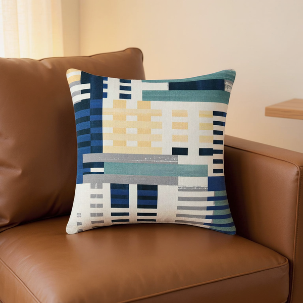 Geometric Print Cotton Slub Pillow in a close view on coordinated upholstered seating