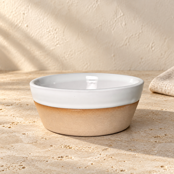 Glazed Stoneware-Style Ceramic Bowl — Single / Snow White, arranged on pale travertine in warm natural light