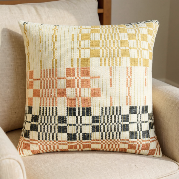 Handwoven Geometric Textile Pillow Cover in a close view on coordinated upholstered seating
