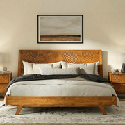 Carved Rubber Wood Platform Bed Frame styled with linen bedding in a warm bedroom