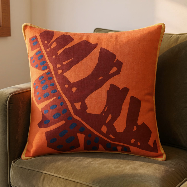Orange Leaf Sketch Cotton Slub Throw Pillow with burgundy leaf print and blue accents on muted olive seating
