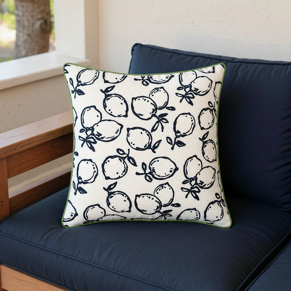 Lemon Print Reversible Outdoor Throw Pillow in a close view on coordinated upholstered seating