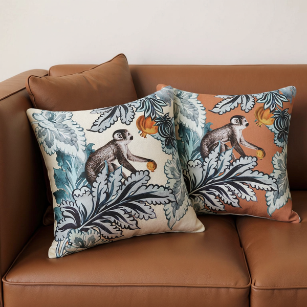 Color options for Printed Cotton Jungle Throw Pillow grouped on coordinated upholstered seating