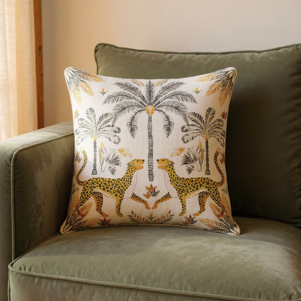 Printed Cotton Leopard Throw Pillow in a close view on coordinated upholstered seating