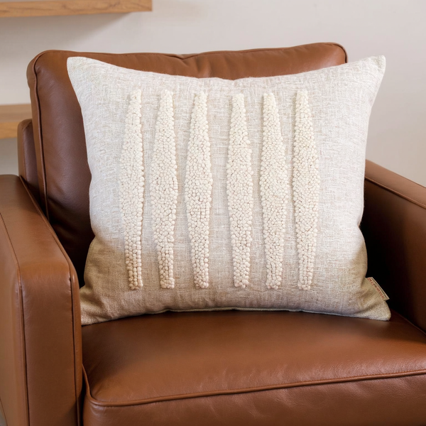 Punch Needle Cotton Throw Pillow in a close view on coordinated upholstered seating