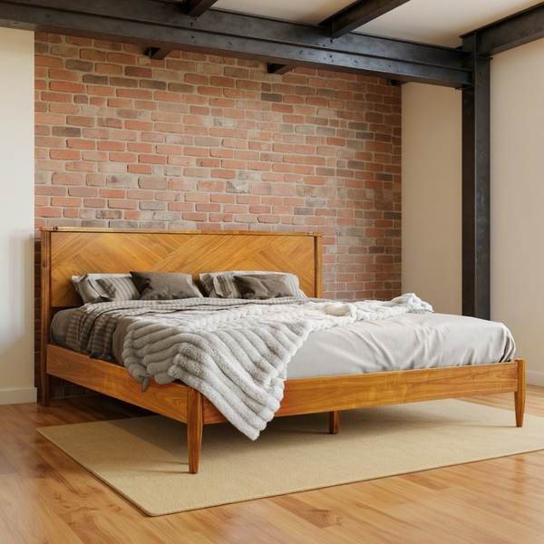 Chevron-panel solid wood bed with layered ivory bedding in a warm brick and steel loft bedroom on a flat oatmeal rug.