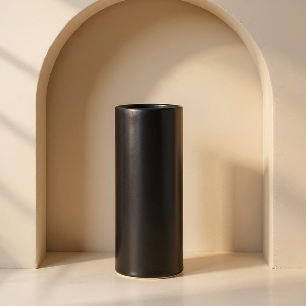 Satin Glaze Porcelain Cylinder Vase in a cream plaster niche with warm natural side light