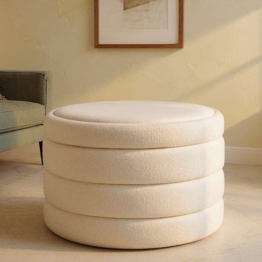 Boucle Round Storage Ottoman on a travertine floor in a sunlit room with cream limewash walls